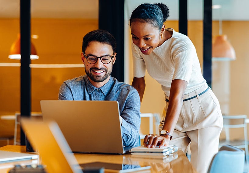 two professionals looking at laptop