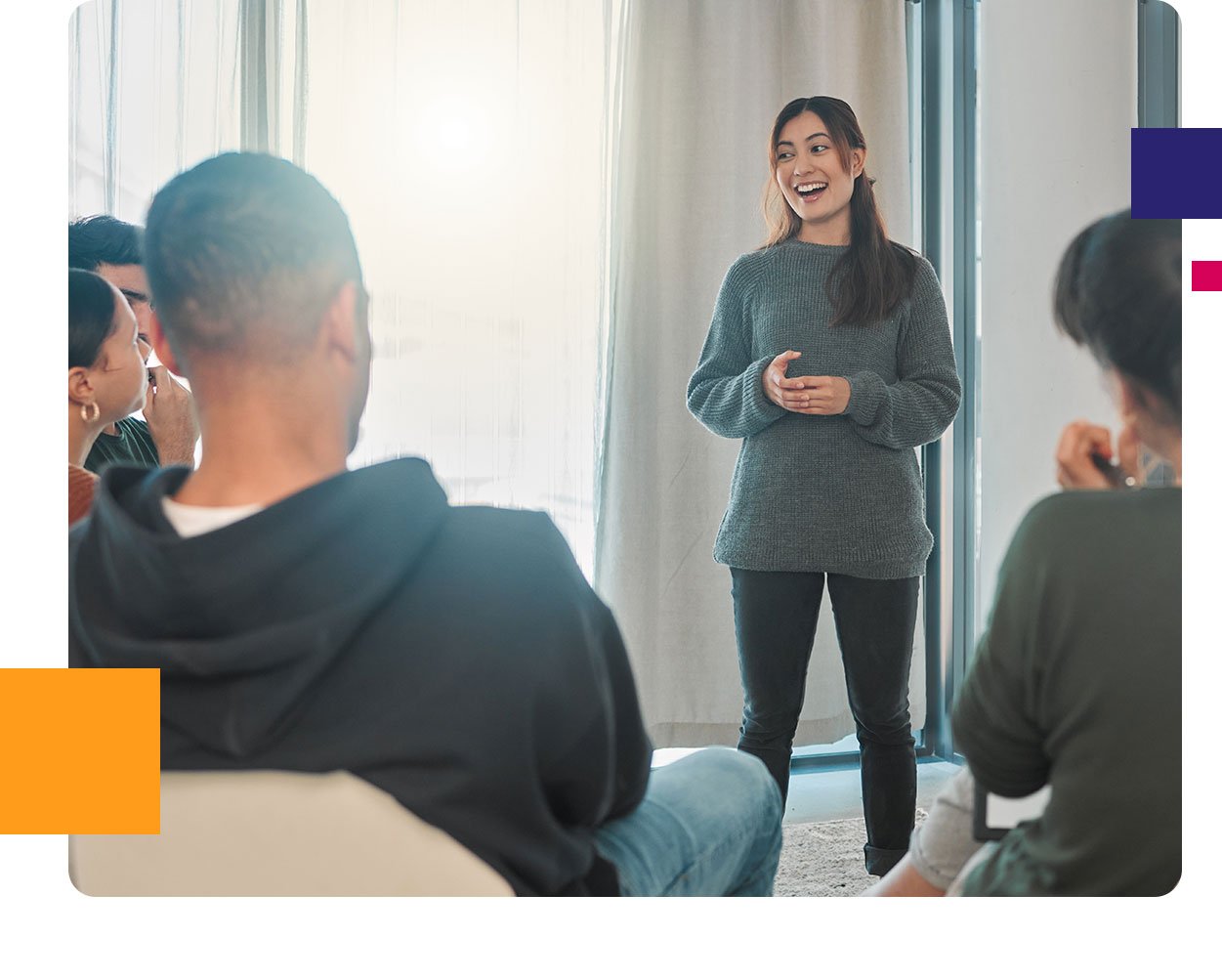 woman speaking standing up in front of group