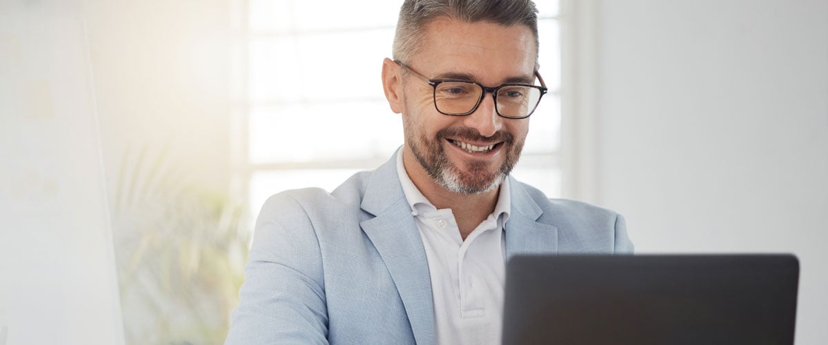 Man smiling looking at laptop