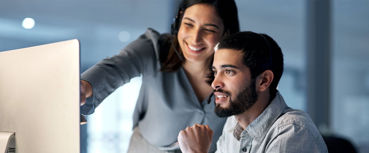 Two professionals looking at a computer screen